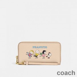 Coach Lange Geldbörse mit Rundum-Reißverschluss aus strukturiertem Leder mit Peanuts-Motiv „Snoopy and Friends“ in Aprikose