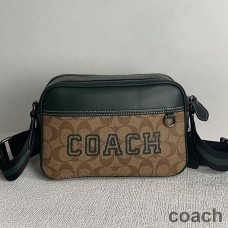 Coach Graham torba preko ramena od prepoznatljivog platna s kaki/zelenim motivom sveučilišta