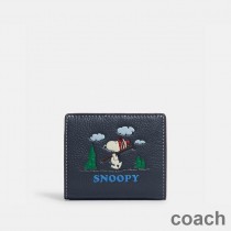 Portfel Coach Snap w kolorze Pebble Leather z motywem narciarskim Peanuts Snoopy w kolorze granatowym