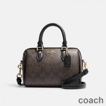 Bolso de mano Coach Mini Rowan en lona distintiva marrón/negro